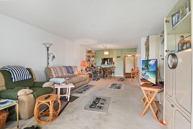 carpeted living room featuring a textured ceiling