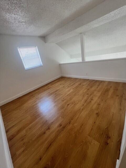 3200 Coral Springs Dr Unit 103, Coral Springs, FL 33065 - additional living space featuring wood-type flooring and a textured ceiling