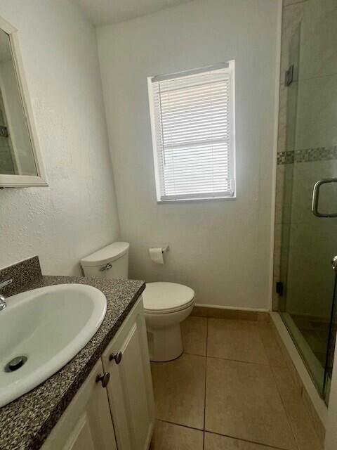 3200 Coral Springs Dr Unit 103, Coral Springs, FL 33065 - bathroom with an enclosed shower, vanity, tile patterned floors, and toilet