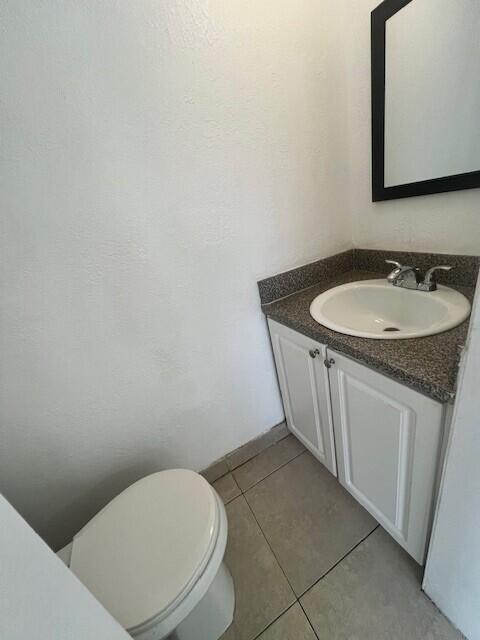 3200 Coral Springs Dr Unit 103, Coral Springs, FL 33065 - bathroom with vanity, toilet, and tile patterned flooring