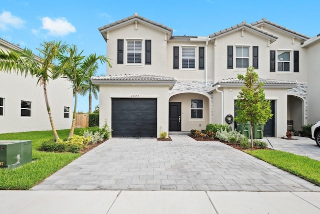 mediterranean / spanish house with a garage