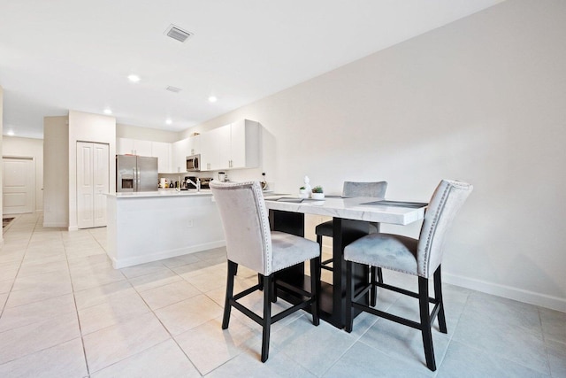 dining room featuring light tile patterned flooring