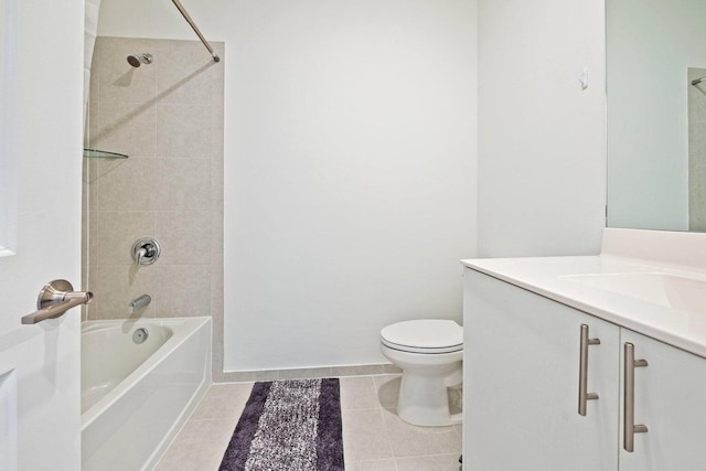 full bathroom featuring tiled shower / bath, vanity, toilet, and tile patterned flooring