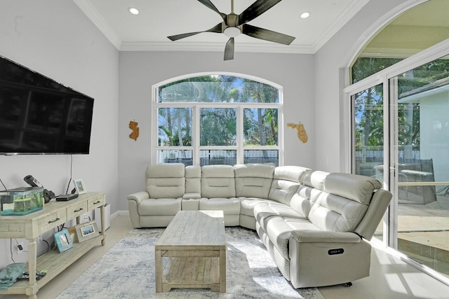 living room with ornamental molding and ceiling fan