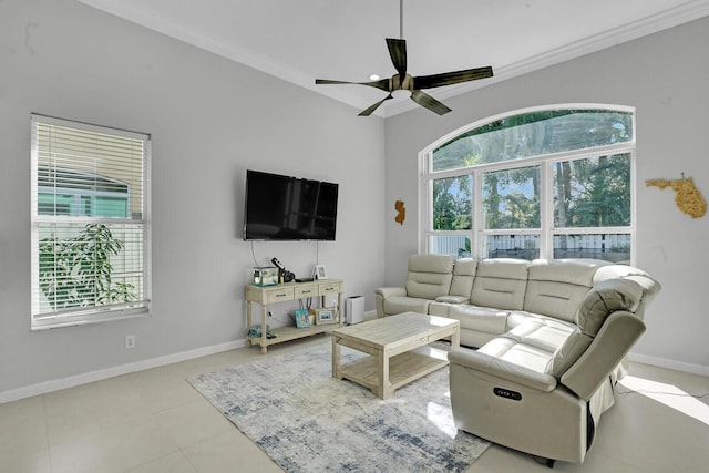 tiled living room featuring ceiling fan and ornamental molding