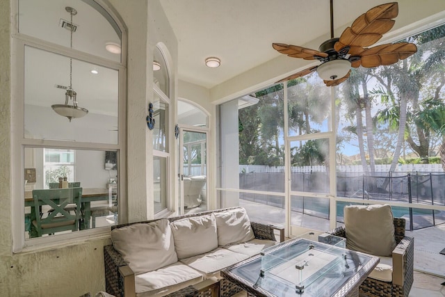 sunroom featuring ceiling fan