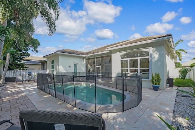 view of swimming pool featuring a patio area, fence, and a fenced in pool