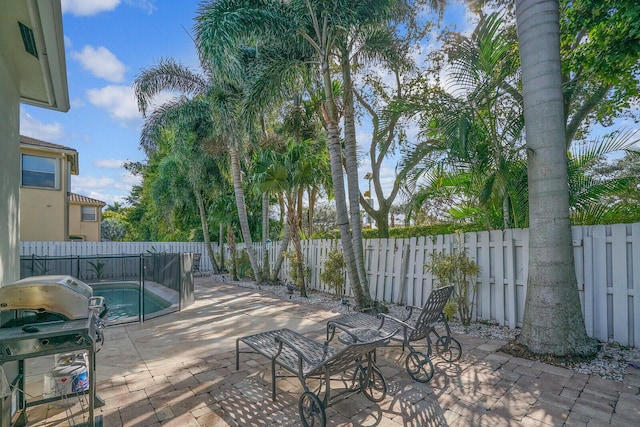 exterior space with a fenced backyard, grilling area, and a fenced in pool