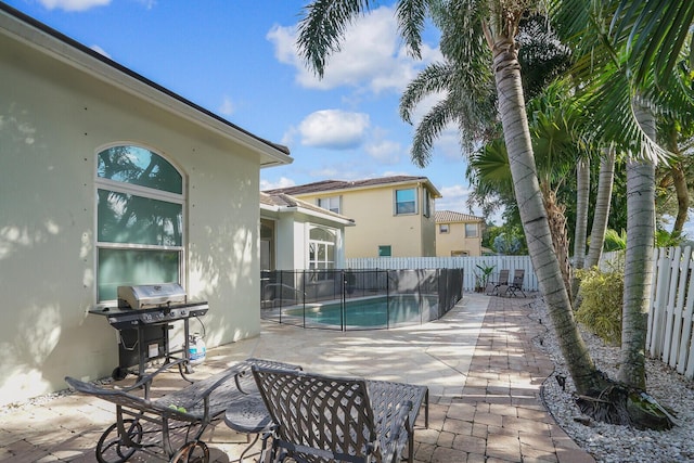 view of pool with a grill, a fenced in pool, a fenced backyard, and a patio