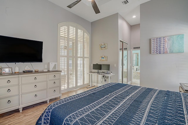 bedroom with a ceiling fan, light wood-type flooring, visible vents, and ensuite bath