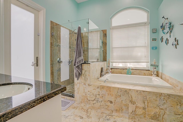 full bathroom featuring vanity, a shower stall, and a bath