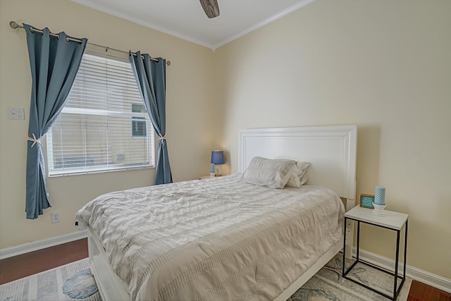 bedroom featuring crown molding, baseboards, and wood finished floors