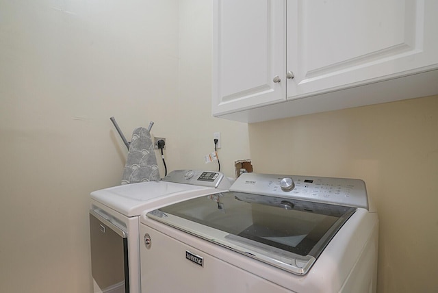 laundry room with cabinet space and washing machine and dryer