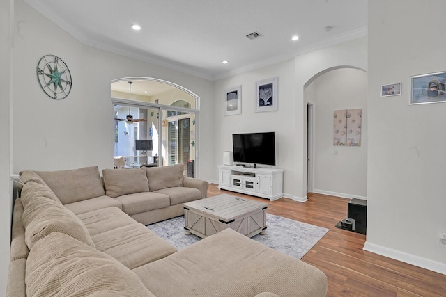 living room featuring ornamental molding, ceiling fan, and light hardwood / wood-style floors