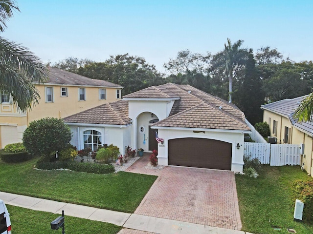 view of front of property featuring a garage and a front lawn