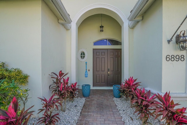 entrance to property featuring stucco siding