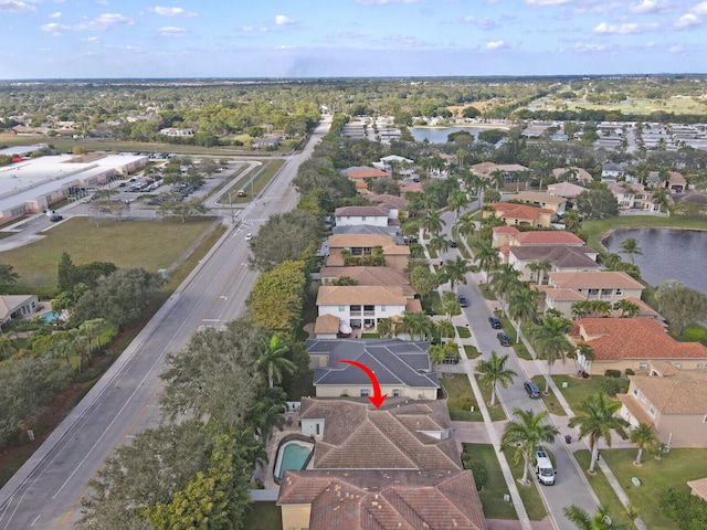 birds eye view of property with a water view and a residential view