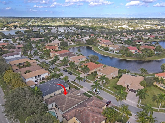 drone / aerial view with a residential view and a water view