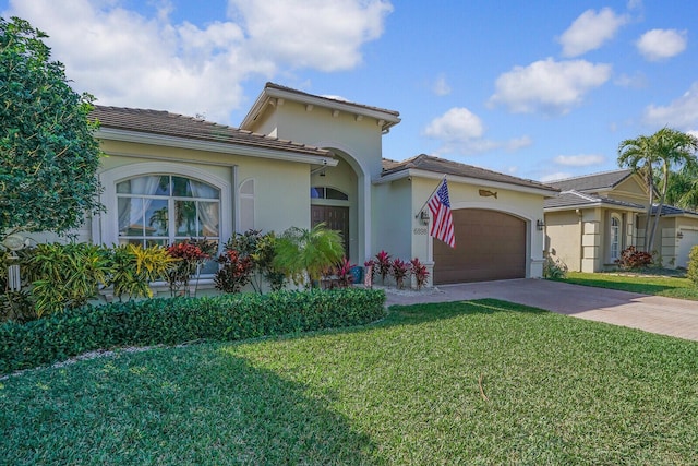 view of front of home featuring a front yard, decorative driveway, an attached garage, and stucco siding