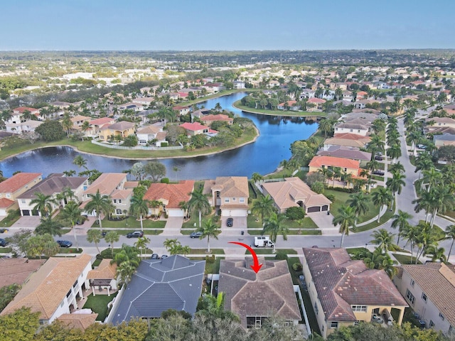 birds eye view of property with a water view and a residential view