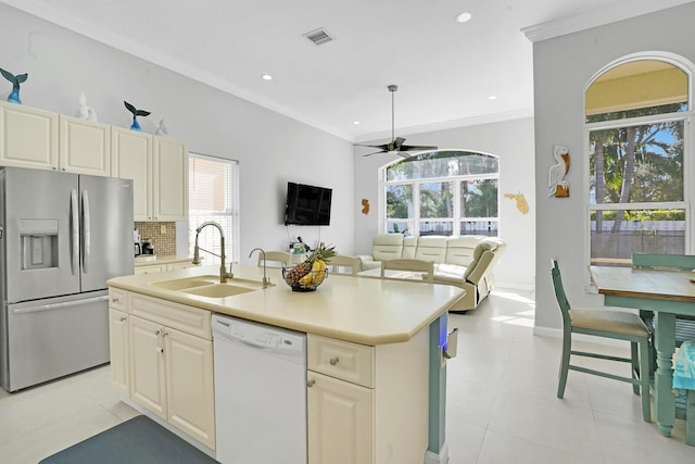 kitchen with ornamental molding, a sink, white dishwasher, stainless steel refrigerator with ice dispenser, and backsplash