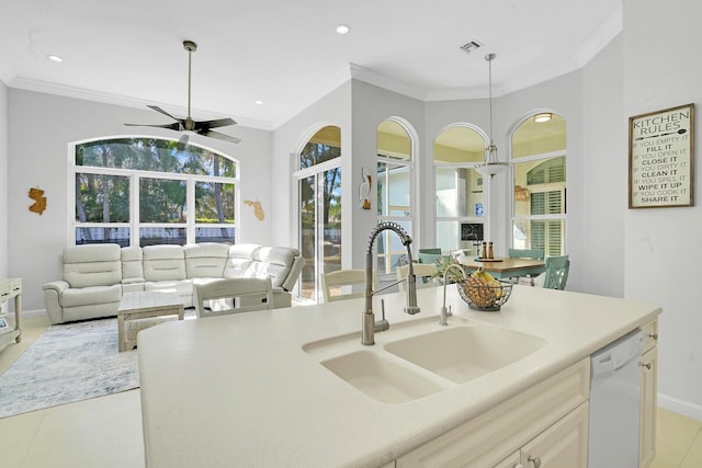 kitchen with white dishwasher, a sink, visible vents, open floor plan, and crown molding