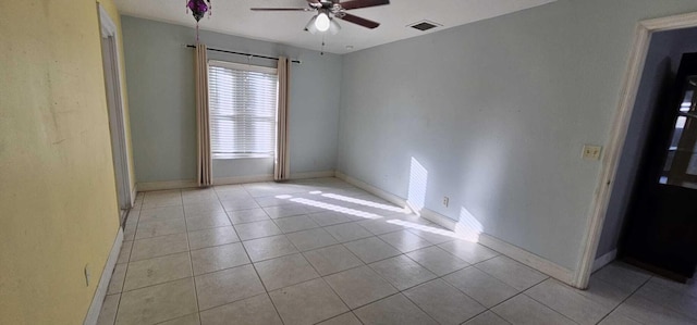 empty room featuring light tile patterned floors and ceiling fan