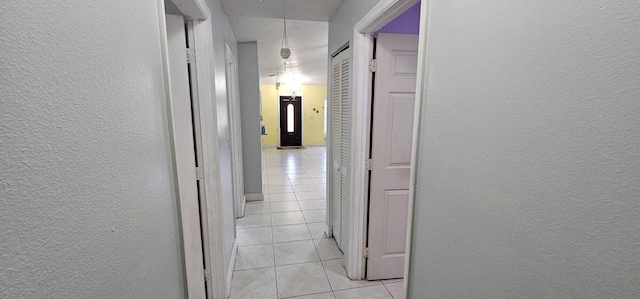 corridor featuring light tile patterned flooring