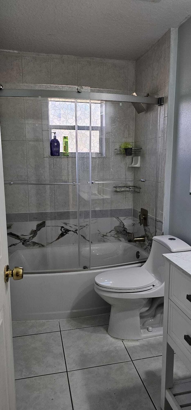 full bathroom featuring tile patterned flooring, enclosed tub / shower combo, vanity, and toilet