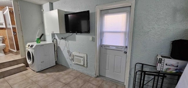 laundry room featuring washer / clothes dryer, a wall mounted AC, and light tile patterned flooring