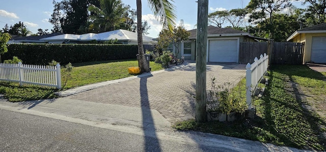 view of front of house featuring a garage and a front yard