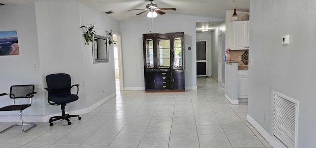 office area featuring lofted ceiling, light tile patterned floors, and ceiling fan