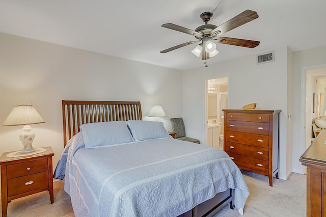 carpeted bedroom featuring ceiling fan and ensuite bathroom