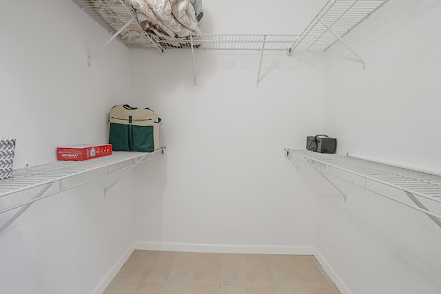 spacious closet with tile patterned flooring