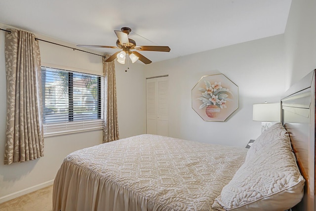 bedroom featuring light carpet, ceiling fan, and a closet