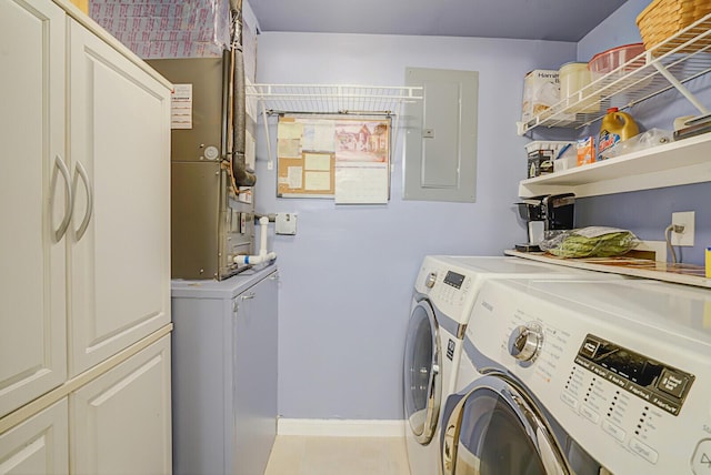 washroom featuring independent washer and dryer, electric panel, and cabinets