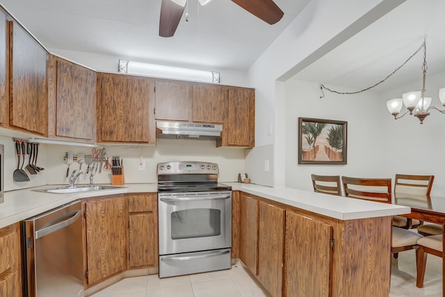 kitchen featuring sink, hanging light fixtures, light tile patterned floors, kitchen peninsula, and stainless steel appliances