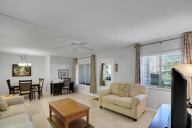 living room with ceiling fan with notable chandelier