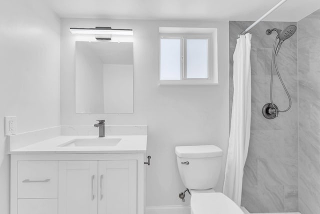 bathroom featuring a shower with curtain, vanity, and toilet