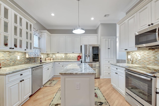6718 Jog Palm Dr, Boynton Beach, FL 33437 - kitchen with stainless steel appliances, backsplash, white cabinets, a sink, and ornamental molding