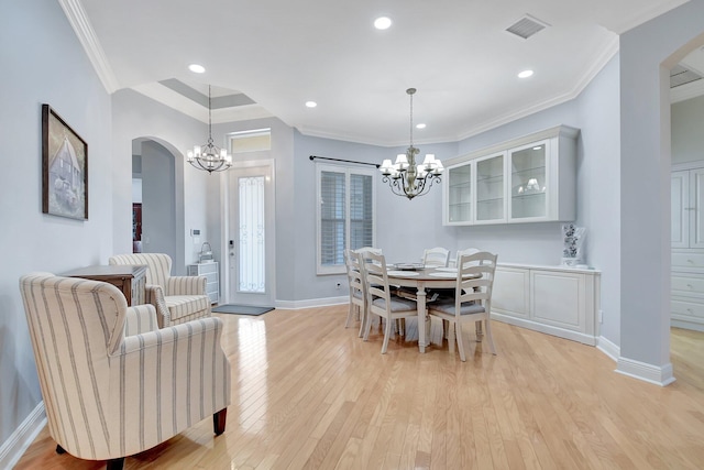 6718 Jog Palm Dr, Boynton Beach, FL 33437 - dining space with arched walkways, a chandelier, light wood-style flooring, crown molding, and recessed lighting