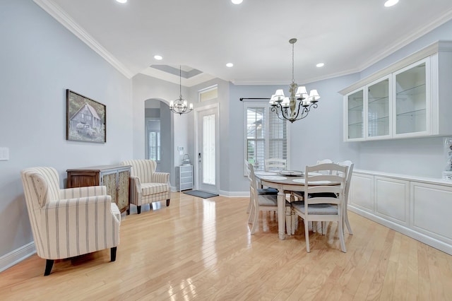6718 Jog Palm Dr, Boynton Beach, FL 33437 - dining room with a chandelier, arched walkways, recessed lighting, light wood-type flooring, and ornamental molding