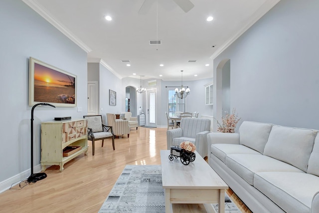 6718 Jog Palm Dr, Boynton Beach, FL 33437 - living area featuring arched walkways, a chandelier, crown molding, light wood finished floors, and recessed lighting