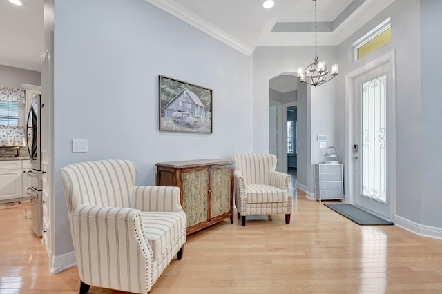 6718 Jog Palm Dr, Boynton Beach, FL 33437 - sitting room with light wood-type flooring, plenty of natural light, a chandelier, crown molding, and baseboards