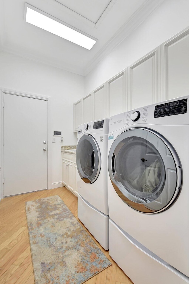 6718 Jog Palm Dr, Boynton Beach, FL 33437 - clothes washing area featuring washer and dryer, cabinet space, ornamental molding, and light wood-style floors