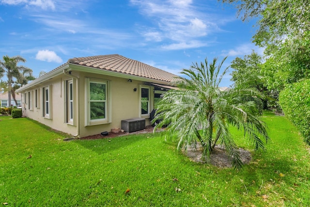 6718 Jog Palm Dr, Boynton Beach, FL 33437 - rear view of property featuring stucco siding, a lawn, and a tile roof