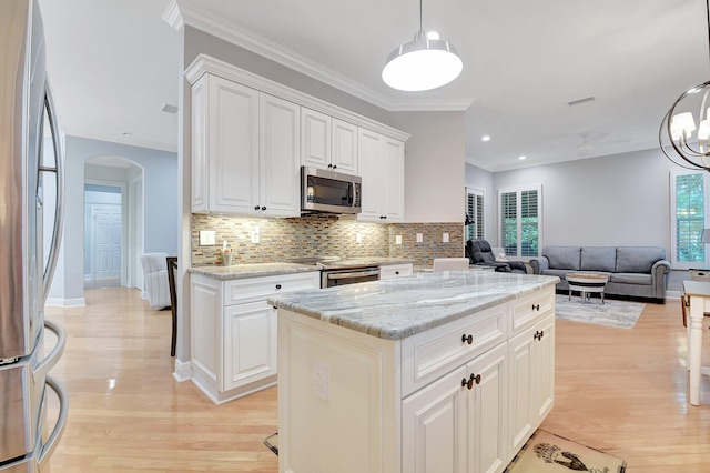 6718 Jog Palm Dr, Boynton Beach, FL 33437 - kitchen with appliances with stainless steel finishes, light wood-style floors, decorative backsplash, white cabinets, and light stone counters