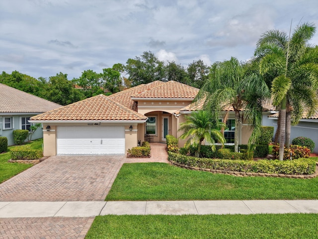 6718 Jog Palm Dr, Boynton Beach, FL 33437 - mediterranean / spanish home with stucco siding, an attached garage, a tiled roof, decorative driveway, and a front lawn