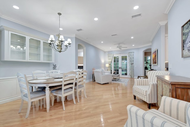 6718 Jog Palm Dr, Boynton Beach, FL 33437 - dining area featuring arched walkways, recessed lighting, ornamental molding, light wood-type flooring, and a chandelier
