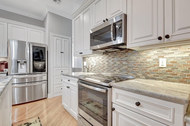 6718 Jog Palm Dr, Boynton Beach, FL 33437 - kitchen with stainless steel appliances, ornamental molding, light wood-type flooring, white cabinets, and decorative backsplash